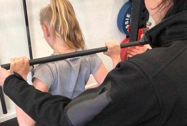 show young person lifting weights